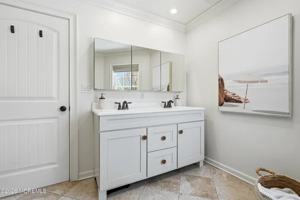 a bathroom with a granite countertop sink a toilet a glass door shower and a mirror