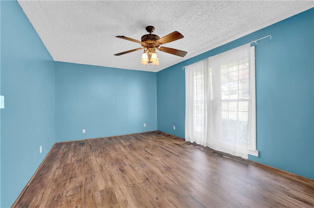 3285 Howell Circle Duluth, GA 30096 - Photo 11 of 33 wooden floor in an empty room with a window
