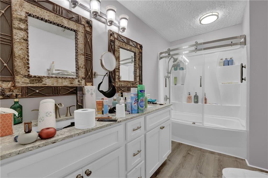 3285 Howell Circle Duluth, GA 30096 - Photo 13 of 33 a bathroom with a tub sink and mirror