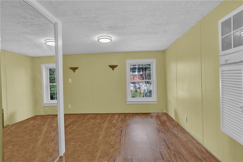 3285 Howell Circle Duluth, GA 30096 - Photo 15 of 33 a view of a hallway with wooden floor and a living room