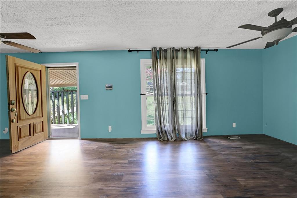 3285 Howell Circle Duluth, GA 30096 - Photo 6 of 33 an empty room with wooden floor and windows