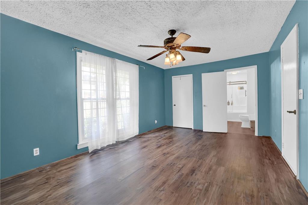 3285 Howell Circle Duluth, GA 30096 - Photo 9 of 33 a view of empty room with wooden floor and fan