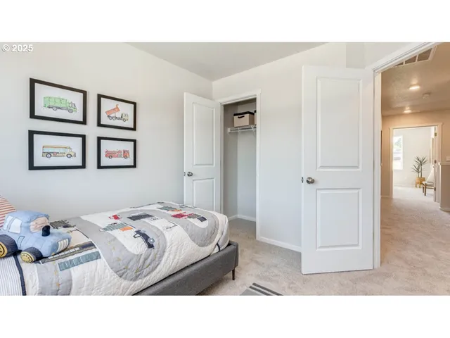 a bedroom with a bed and painting on the wall