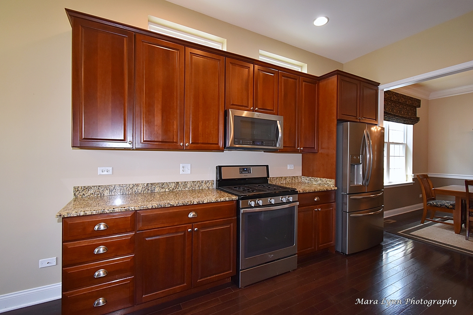 3881 Valhalla Drive Elgin, IL 60124 - Photo 13 of 39 a kitchen with granite countertop wooden cabinets and stainless steel appliances