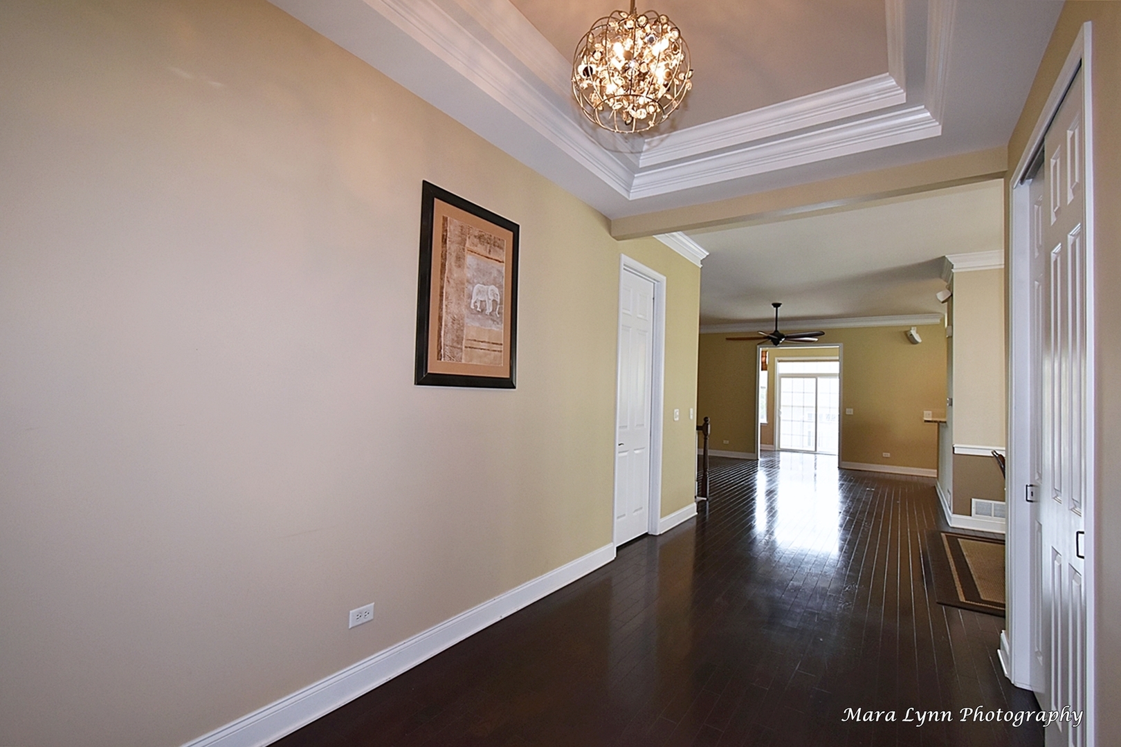 3881 Valhalla Drive Elgin, IL 60124 - Photo 4 of 39 an empty room with wooden floor and a chandelier