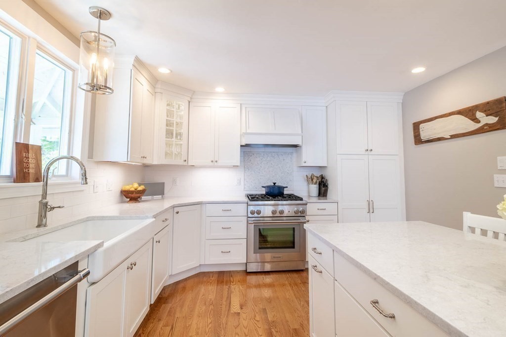 203 Samoset Avenue Hull, MA 02045 - Photo 14 of 39 a kitchen with a sink a stove and cabinets