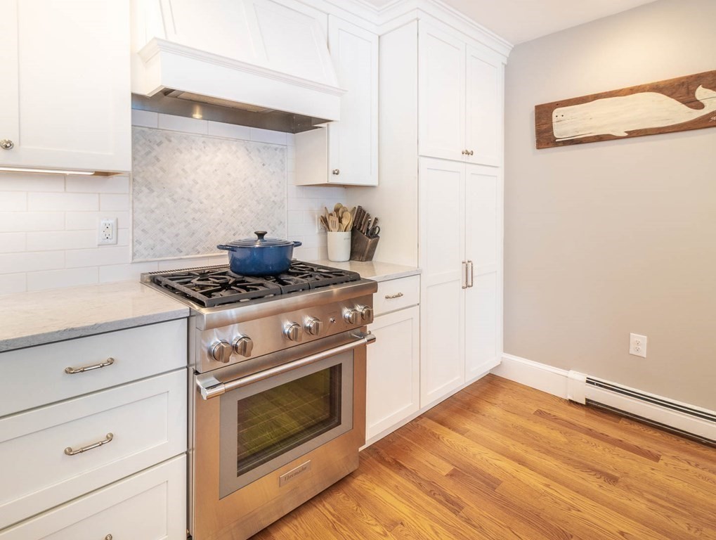 203 Samoset Avenue Hull, MA 02045 - Photo 15 of 39 a kitchen with granite countertop white cabinets and white stove