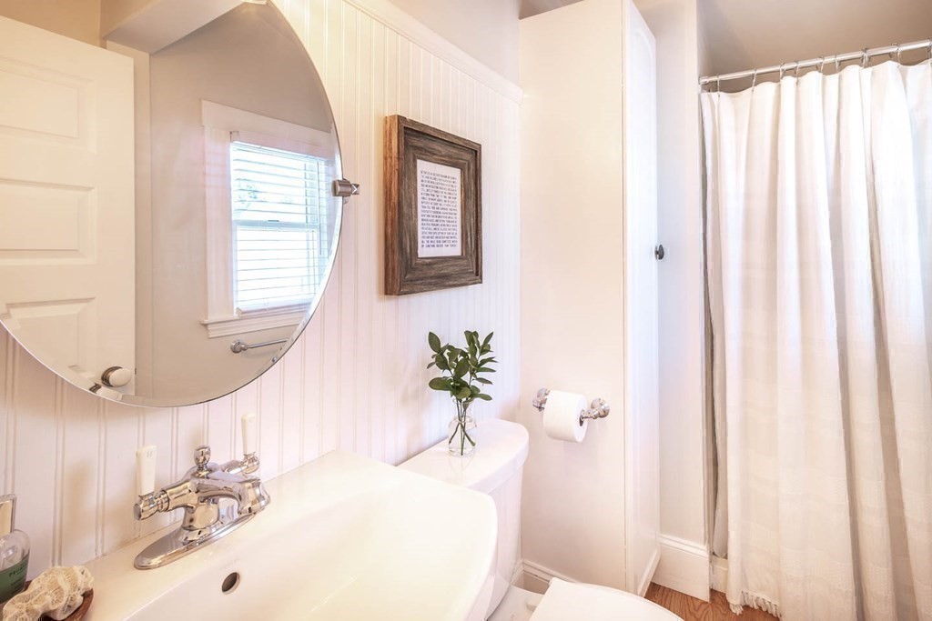 203 Samoset Avenue Hull, MA 02045 - Photo 23 of 39 a bathroom with a sink a toilet and a window