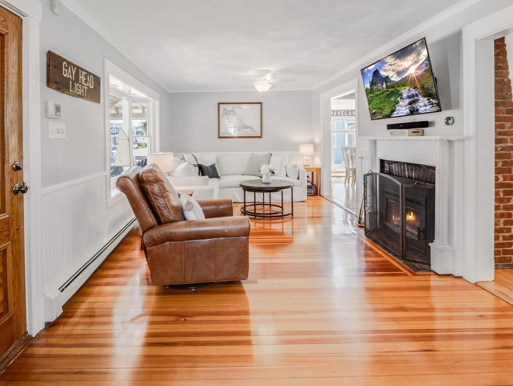 203 Samoset Avenue Hull, MA 02045 - Photo 7 of 39 a living room with furniture a fireplace and a flat screen tv