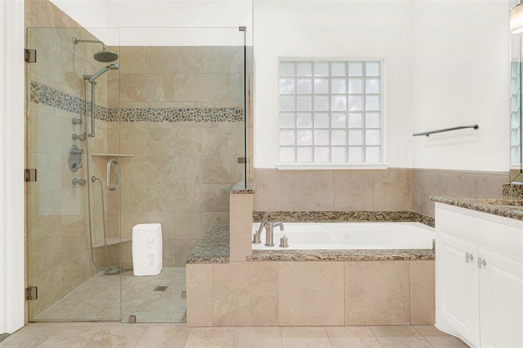 5729 Ridgehaven Drive Plano, TX 75093 - Photo 11 of 21 a bathroom with a bathtub and shower