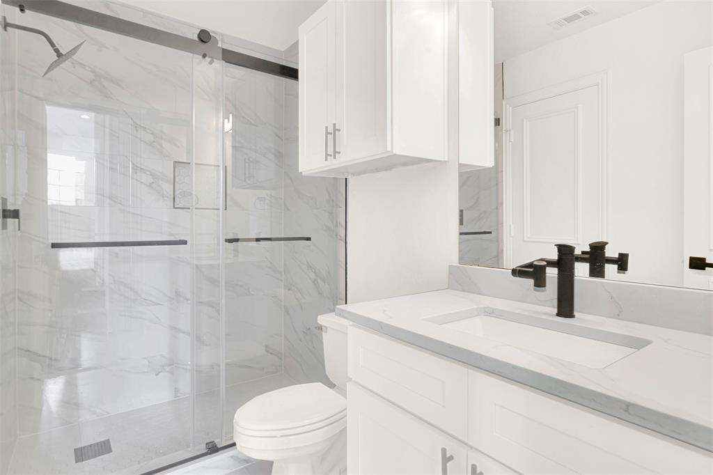 5729 Ridgehaven Drive Plano, TX 75093 - Photo 13 of 21 a bathroom with a sink toilet and shower