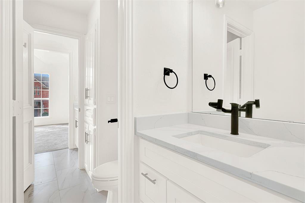 5729 Ridgehaven Drive Plano, TX 75093 - Photo 16 of 21 a bathroom with a sink and a mirror