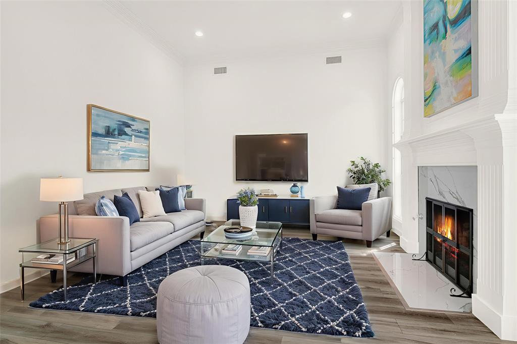 5729 Ridgehaven Drive Plano, TX 75093 - Photo 2 of 21 a living room with furniture a flat screen tv and a fireplace