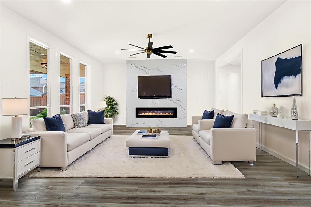 5729 Ridgehaven Drive Plano, TX 75093 - Photo 5 of 21 a living room with furniture flat screen tv and a fireplace