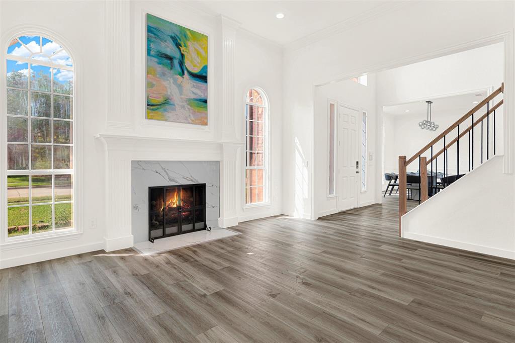 5729 Ridgehaven Drive Plano, TX 75093 - Photo 7 of 21 a view of an empty room with wooden floor fireplace and a window