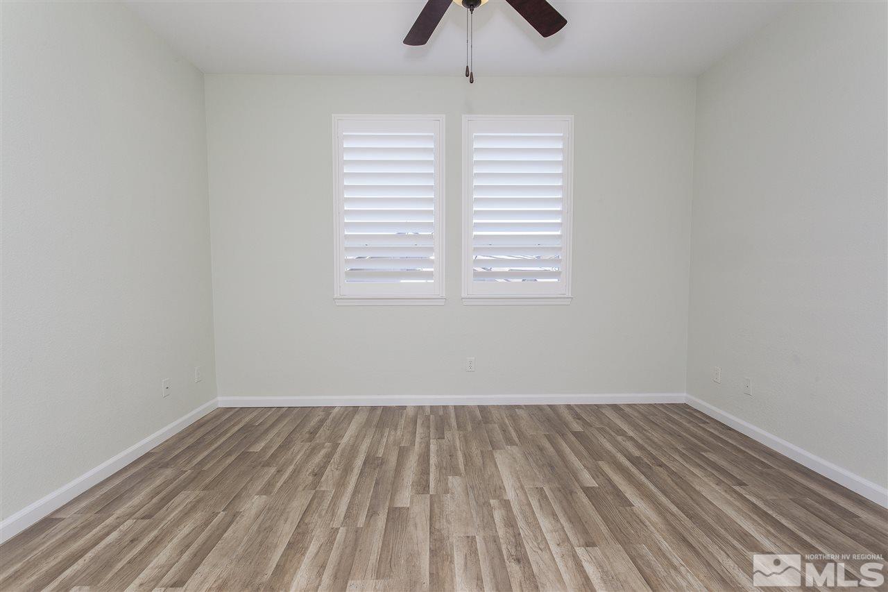 581 Alydar Court Reno, NV 89521 - Photo 13 of 22 wooden floor in an empty room with a window