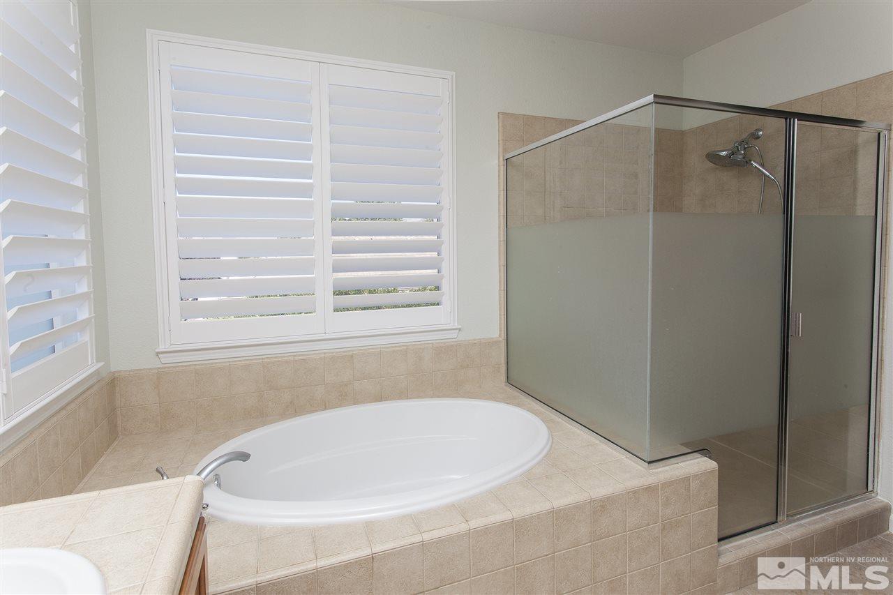 581 Alydar Court Reno, NV 89521 - Photo 15 of 22 a bathroom with a bathtub and a shower