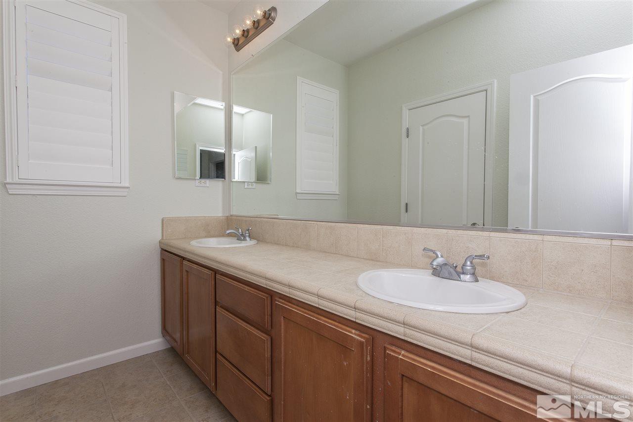 581 Alydar Court Reno, NV 89521 - Photo 18 of 22 a bathroom with a sink and a mirror