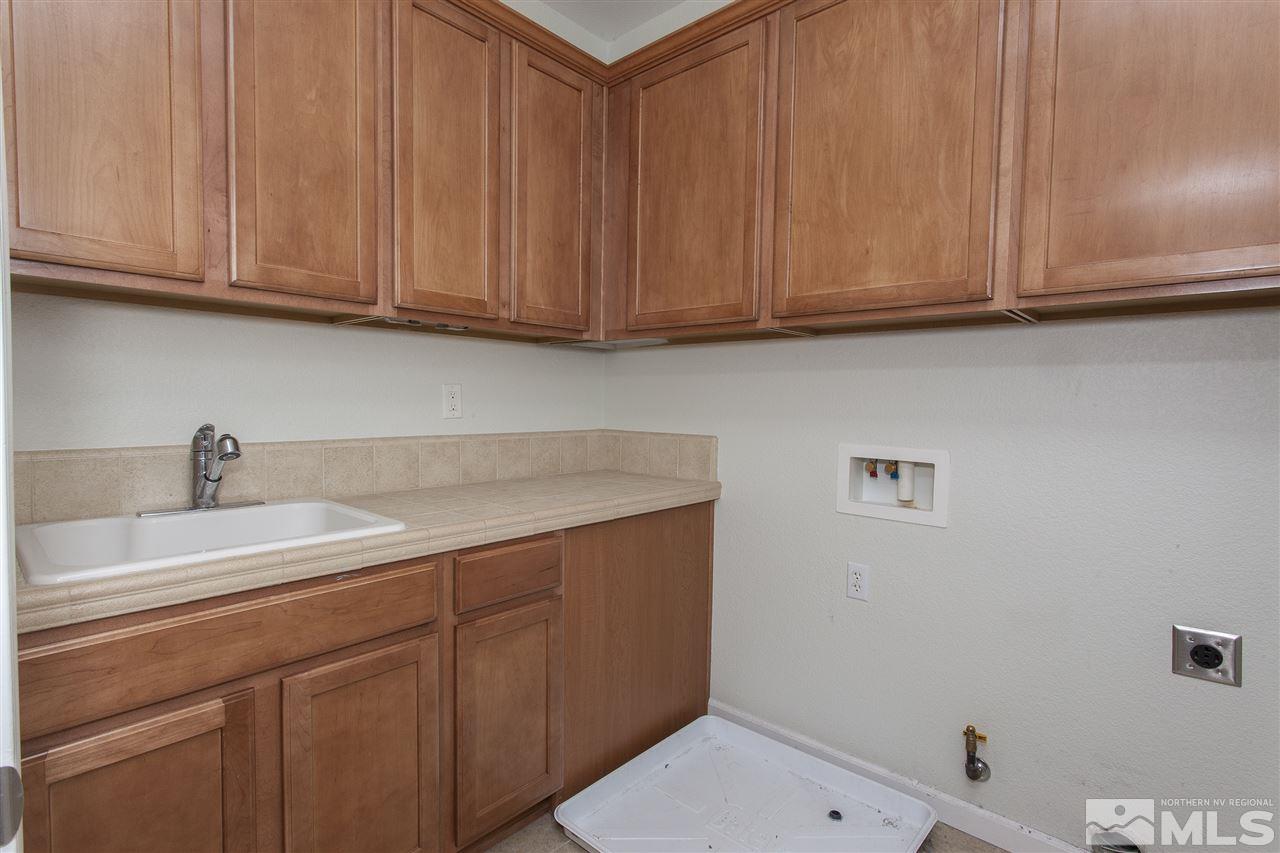 581 Alydar Court Reno, NV 89521 - Photo 20 of 22 a bathroom with a sink and cabinets