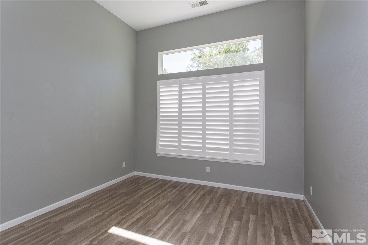 581 Alydar Court Reno, NV 89521 - Photo 8 of 22 an empty room with wooden closet and a window