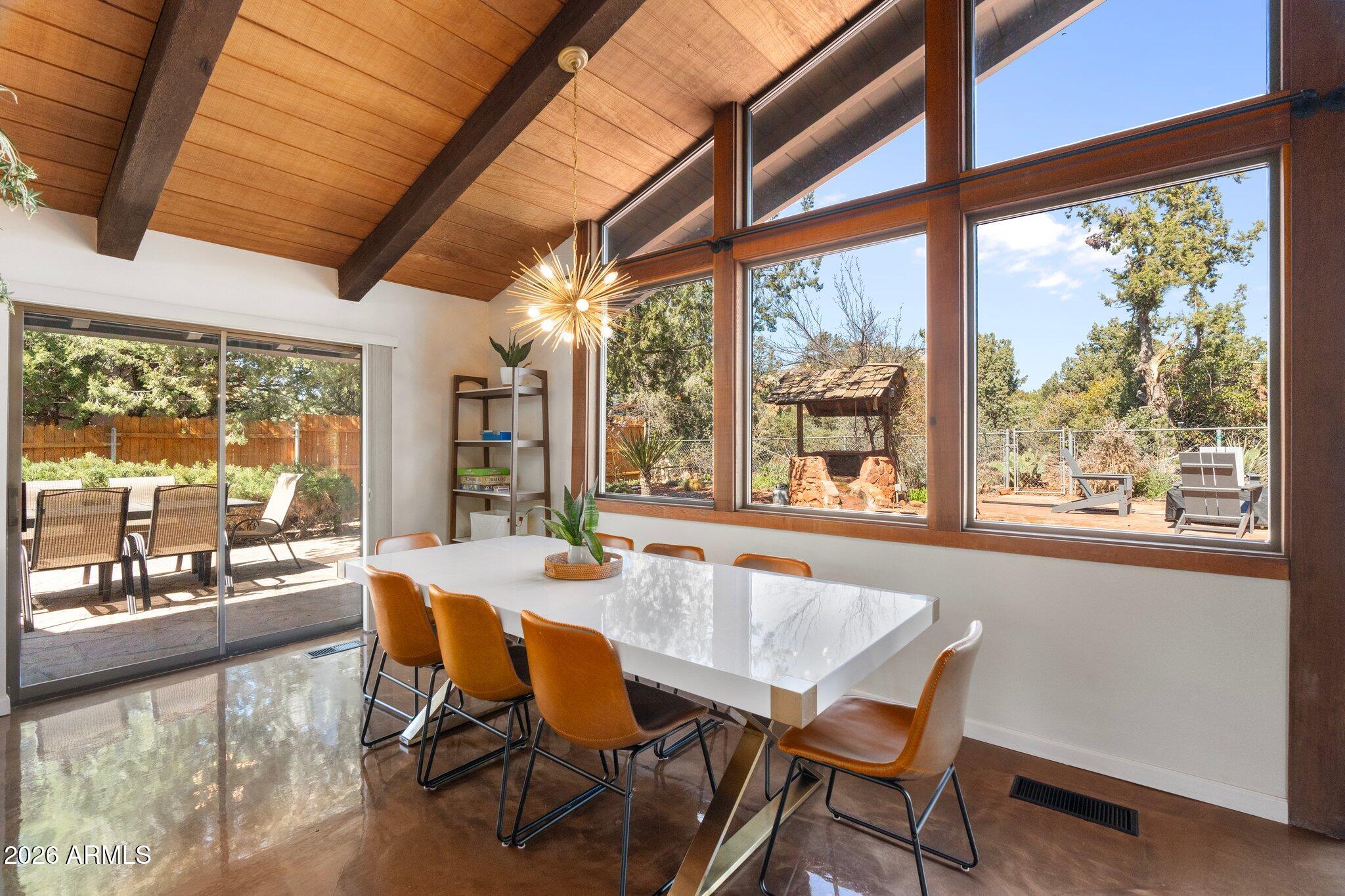 40 Mission Road Sedona, AZ 86336 - Photo 23 of 75 a dining room with furniture a chandelier and wooden floor