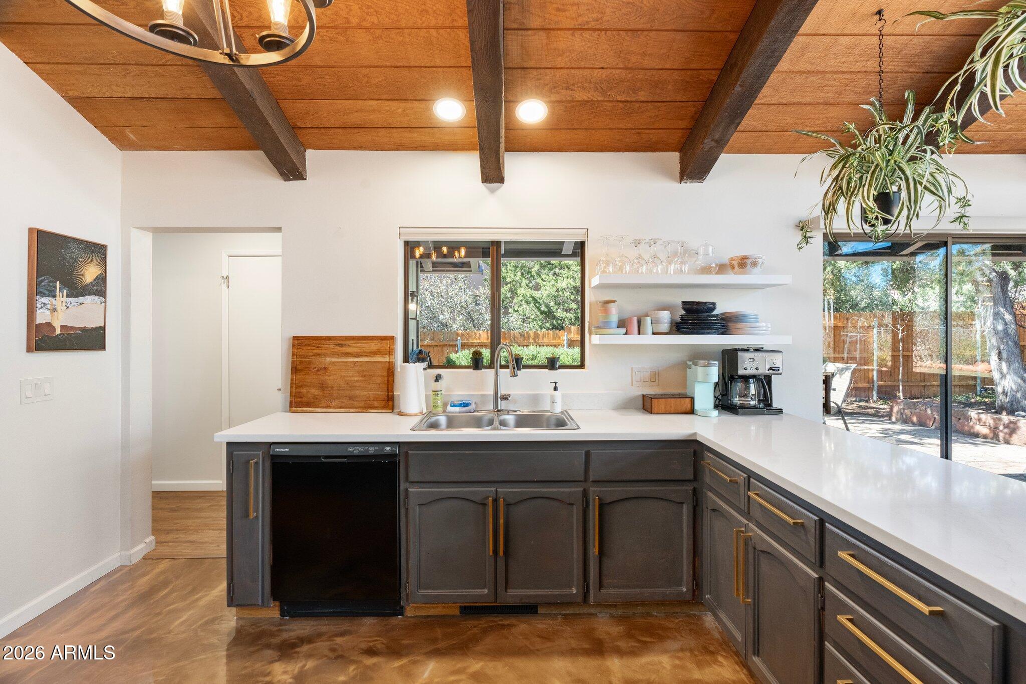 40 Mission Road Sedona, AZ 86336 - Photo 25 of 75 a kitchen with stainless steel appliances granite countertop a sink a stove and a wooden floors
