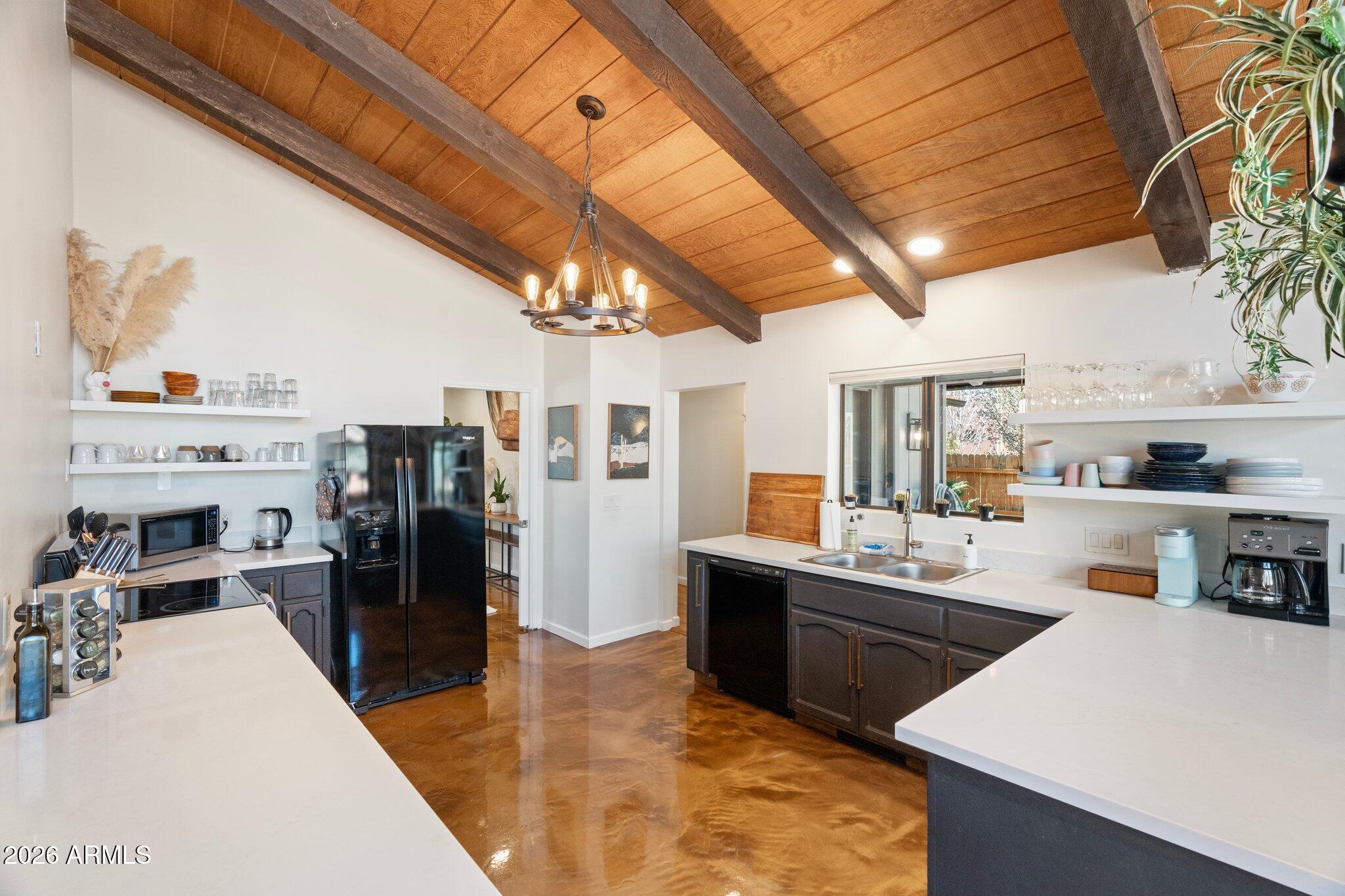 40 Mission Road Sedona, AZ 86336 - Photo 28 of 75 a kitchen with stainless steel appliances kitchen island granite countertop a sink a stove and refrigerator