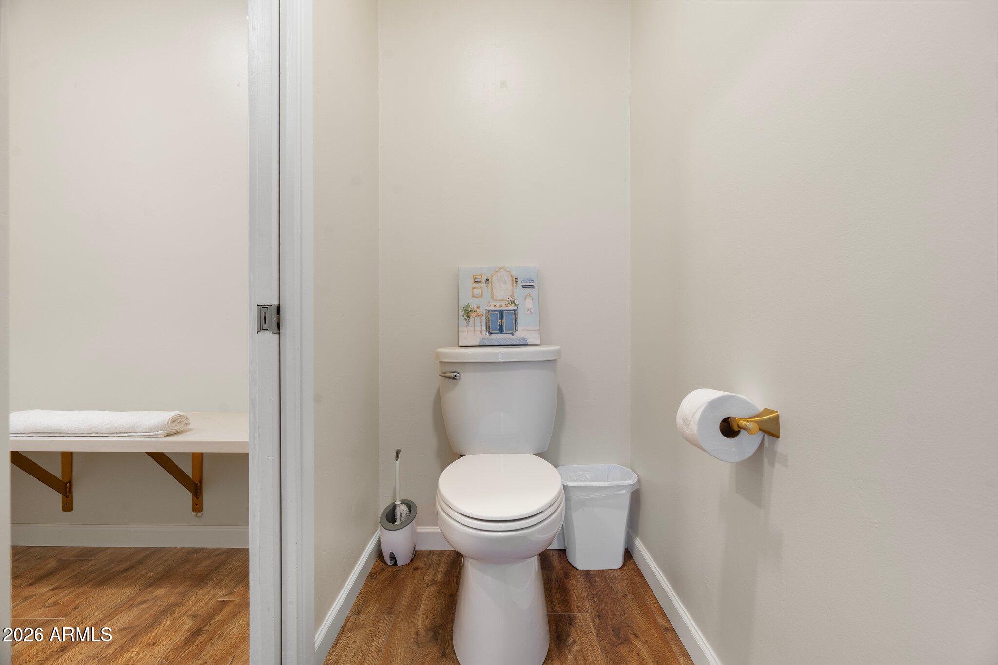 40 Mission Road Sedona, AZ 86336 - Photo 50 of 75 a white toilet sitting in a bathroom next to a small sink