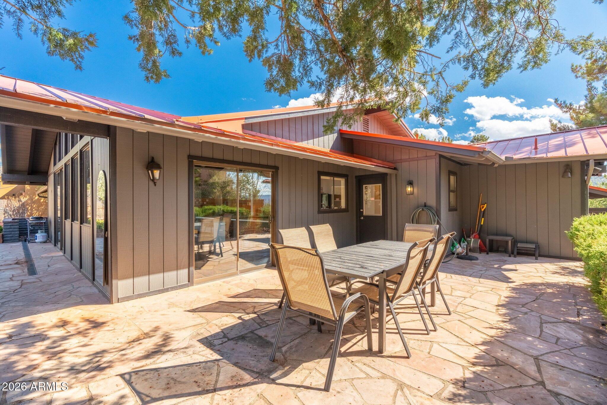 40 Mission Road Sedona, AZ 86336 - Photo 52 of 75 a view of a patio with a table and chairs and potted plants