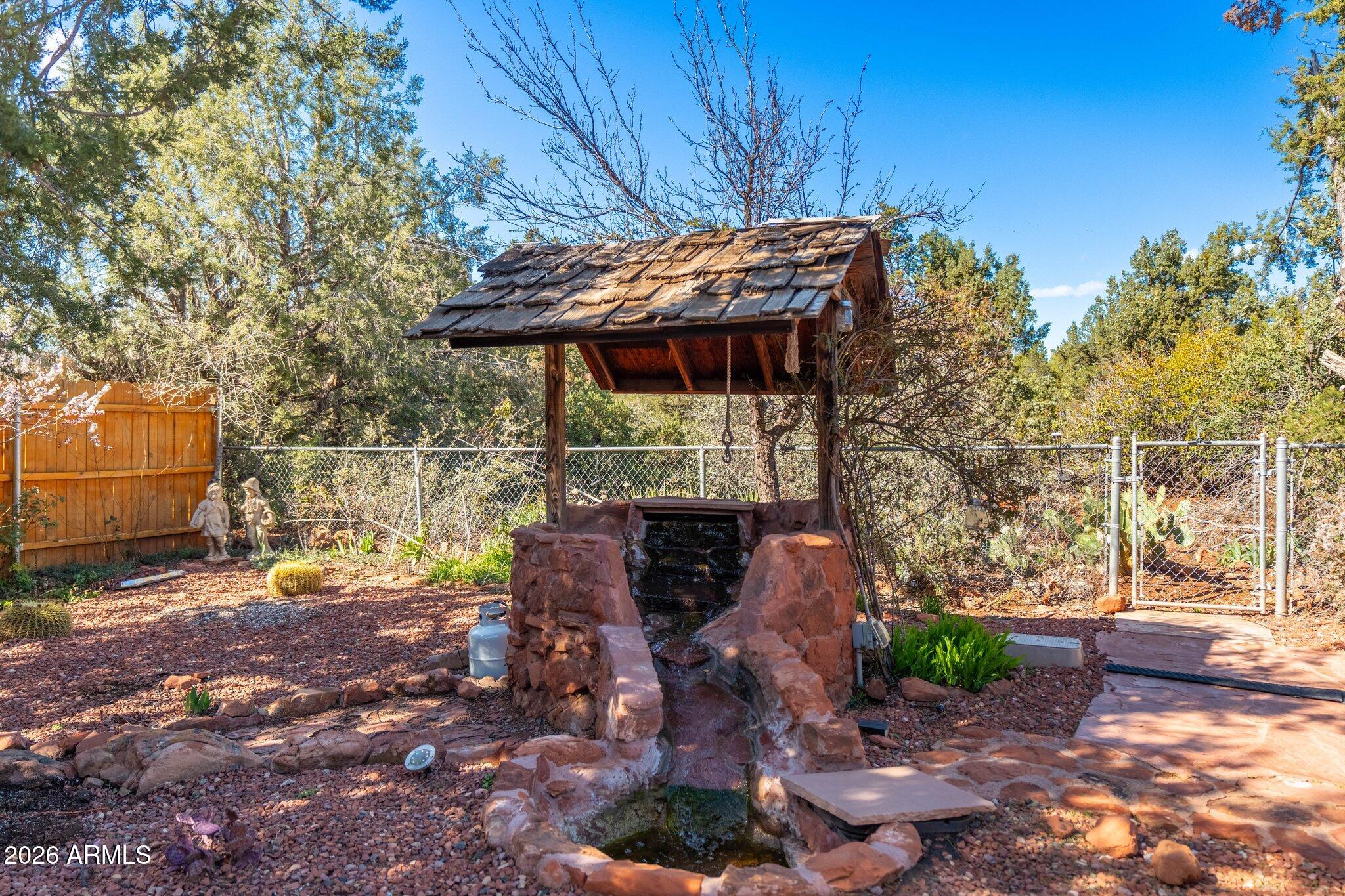 40 Mission Road Sedona, AZ 86336 - Photo 54 of 75 a backyard of a house with barbeque oven