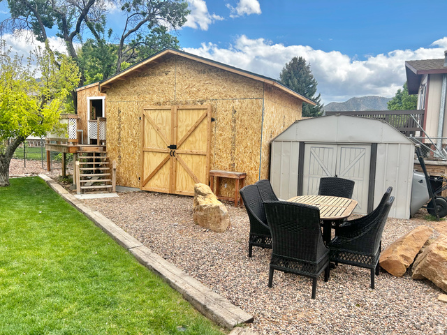 570 250 East Parowan, UT 84761 - Photo 23 of 27 Backyard featuring a new construction storage shed with double barn doors and an elevated platform with stairs