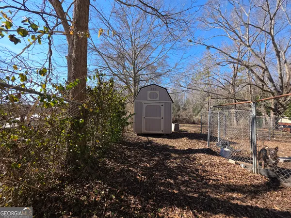 a view of a yard with large trees