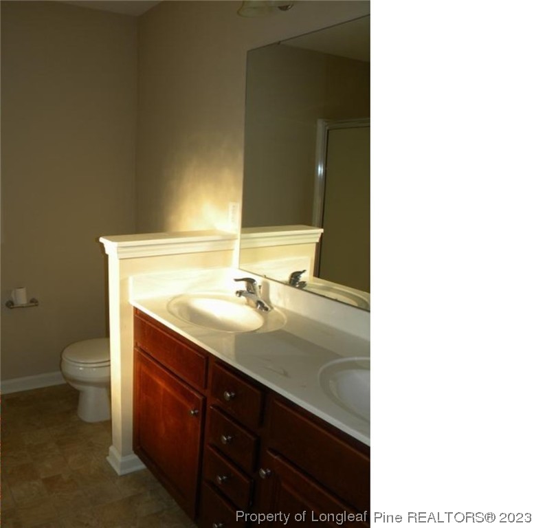 93 Expedition Drive Cameron, NC 28326 - Photo 10 of 19 a bathroom with a sink toilet and mirror