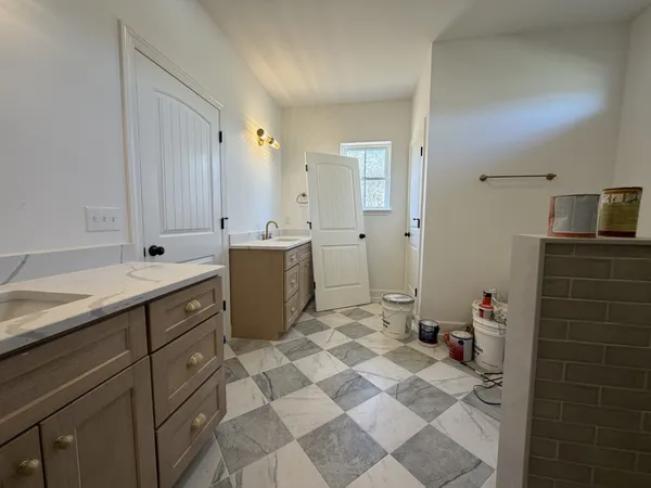 a spacious bathroom with a sink mirror and a shower