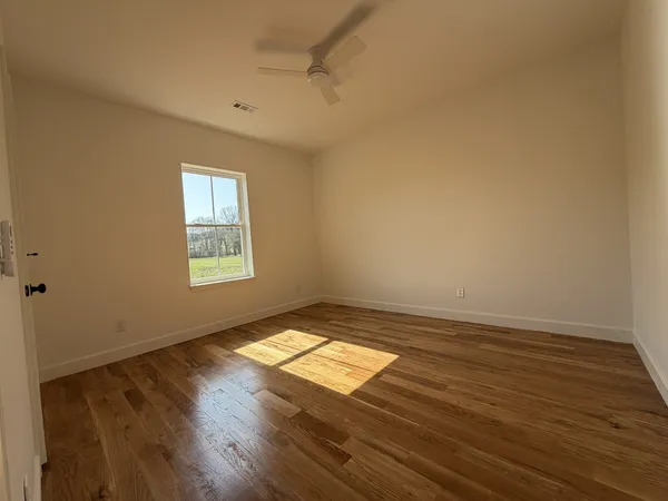 a view of wooden floor and windows in a room