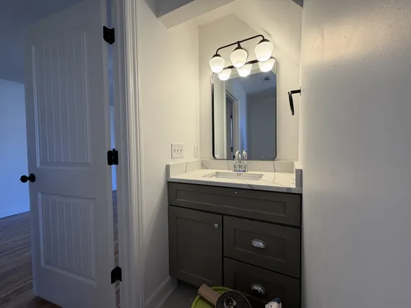 a bathroom with a sink vanity and a mirror
