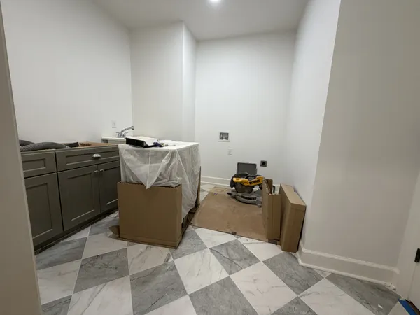a view of a storage & utility room with two washing machine