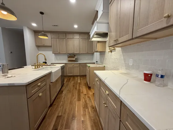a kitchen with a sink a stove and cabinets