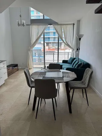 a dining room with furniture and window