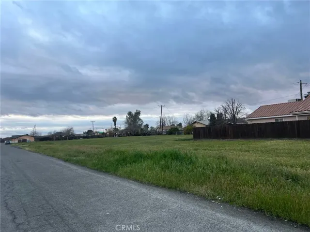a view of a big yard with a house in the background