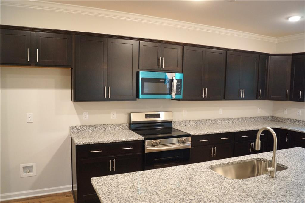 123 Nectar Lane Bunnlevel, NC 28323 - Photo 14 of 36 a kitchen with a sink and cabinets