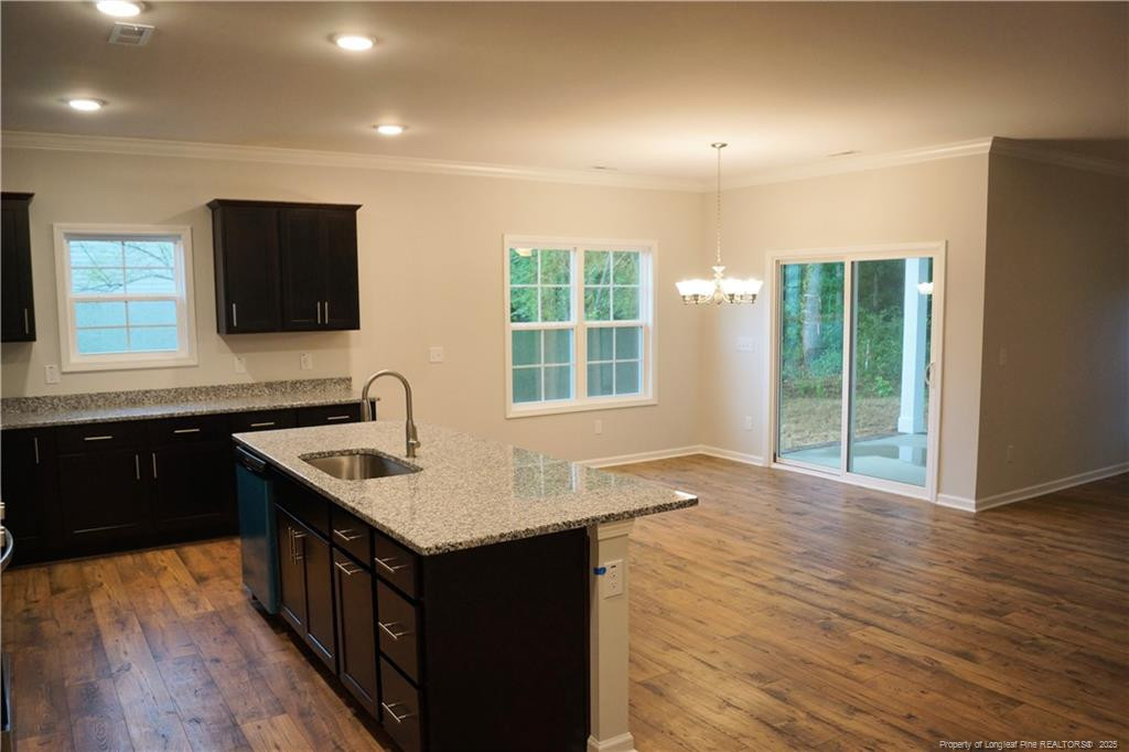 123 Nectar Lane Bunnlevel, NC 28323 - Photo 17 of 36 a kitchen with a stove sink and cabinets