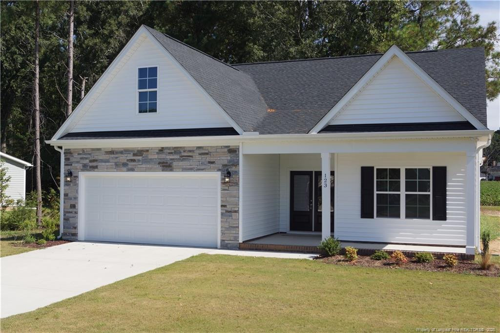 123 Nectar Lane Bunnlevel, NC 28323 - Photo 2 of 36 a front view of a house with a garage