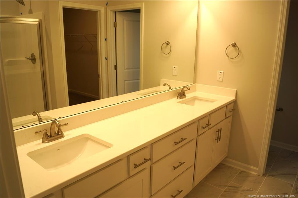 123 Nectar Lane Bunnlevel, NC 28323 - Photo 22 of 36 a bathroom with a sink and a mirror