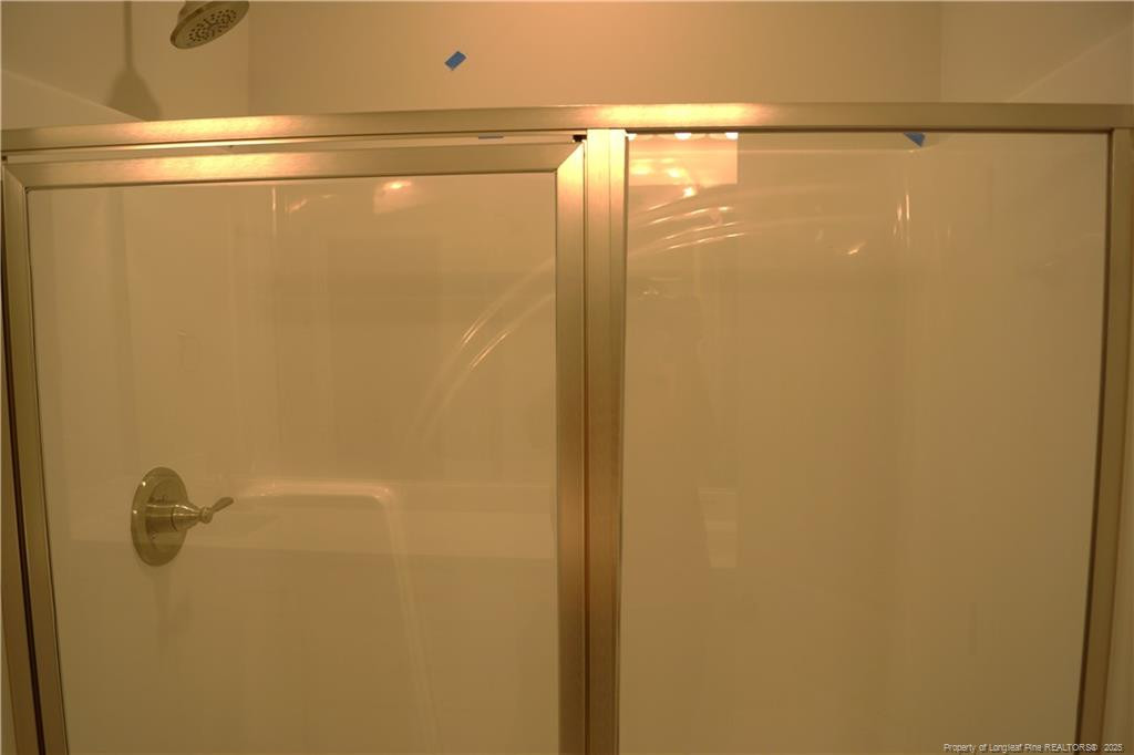 123 Nectar Lane Bunnlevel, NC 28323 - Photo 23 of 36 a bathroom with a glass shower door