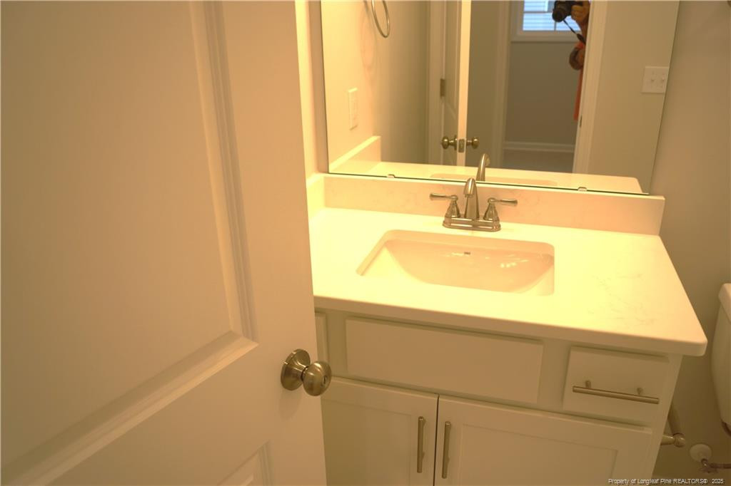 123 Nectar Lane Bunnlevel, NC 28323 - Photo 28 of 36 a bathroom with a granite countertop sink and a mirror