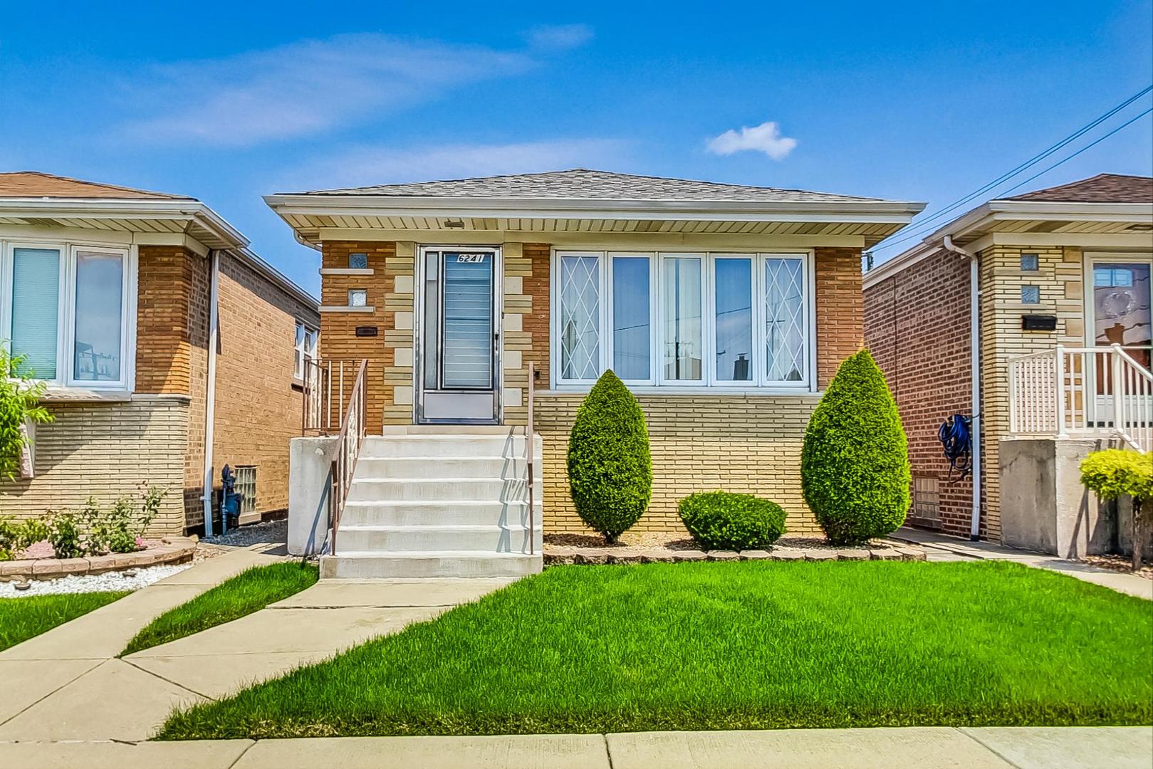 6241 South Rutherford Avenue Chicago, IL 60638 - Photo 1 of 39 a view of a house with a small yard and plants