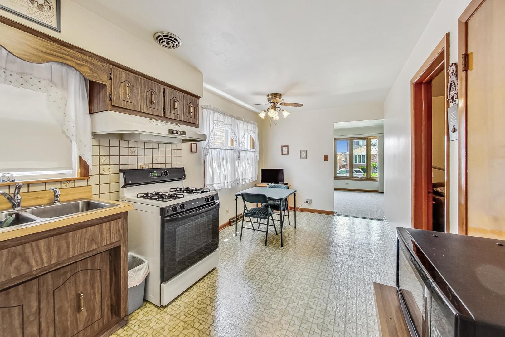 6241 South Rutherford Avenue Chicago, IL 60638 - Photo 11 of 39 a kitchen with stove and cabinets