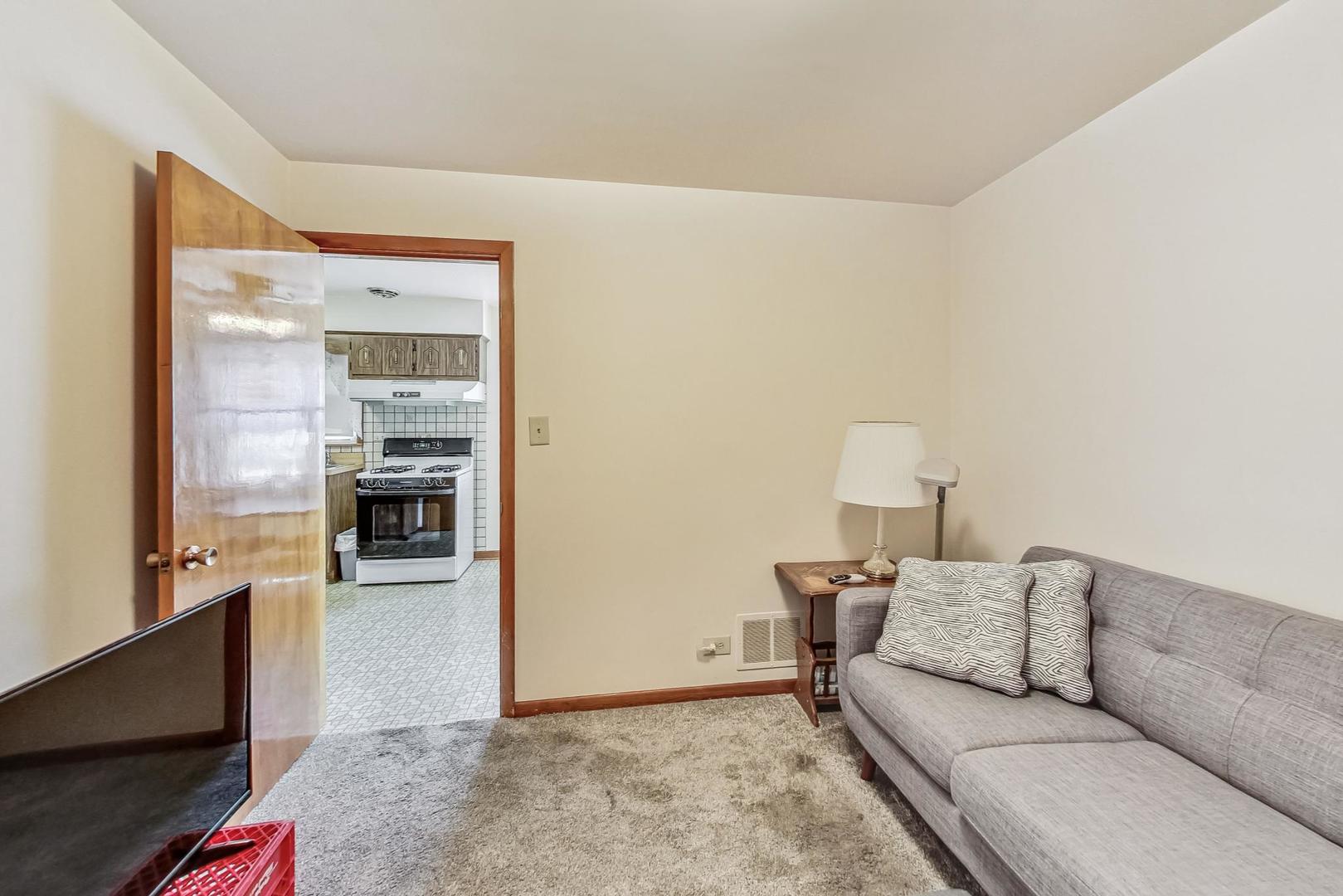 6241 South Rutherford Avenue Chicago, IL 60638 - Photo 14 of 39 a living room with furniture and a flat screen tv