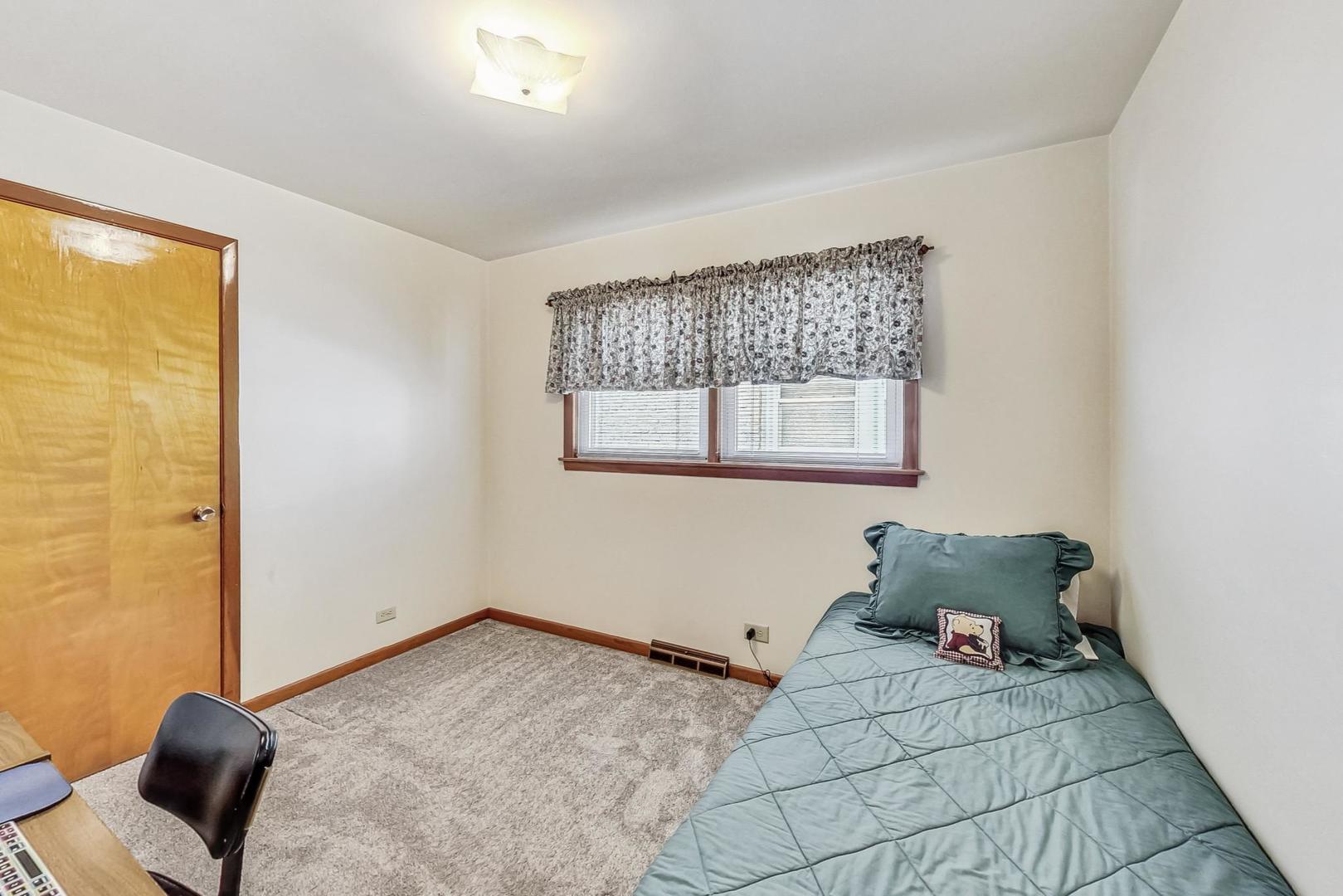 6241 South Rutherford Avenue Chicago, IL 60638 - Photo 15 of 39 a bedroom with a bed and wooden floor